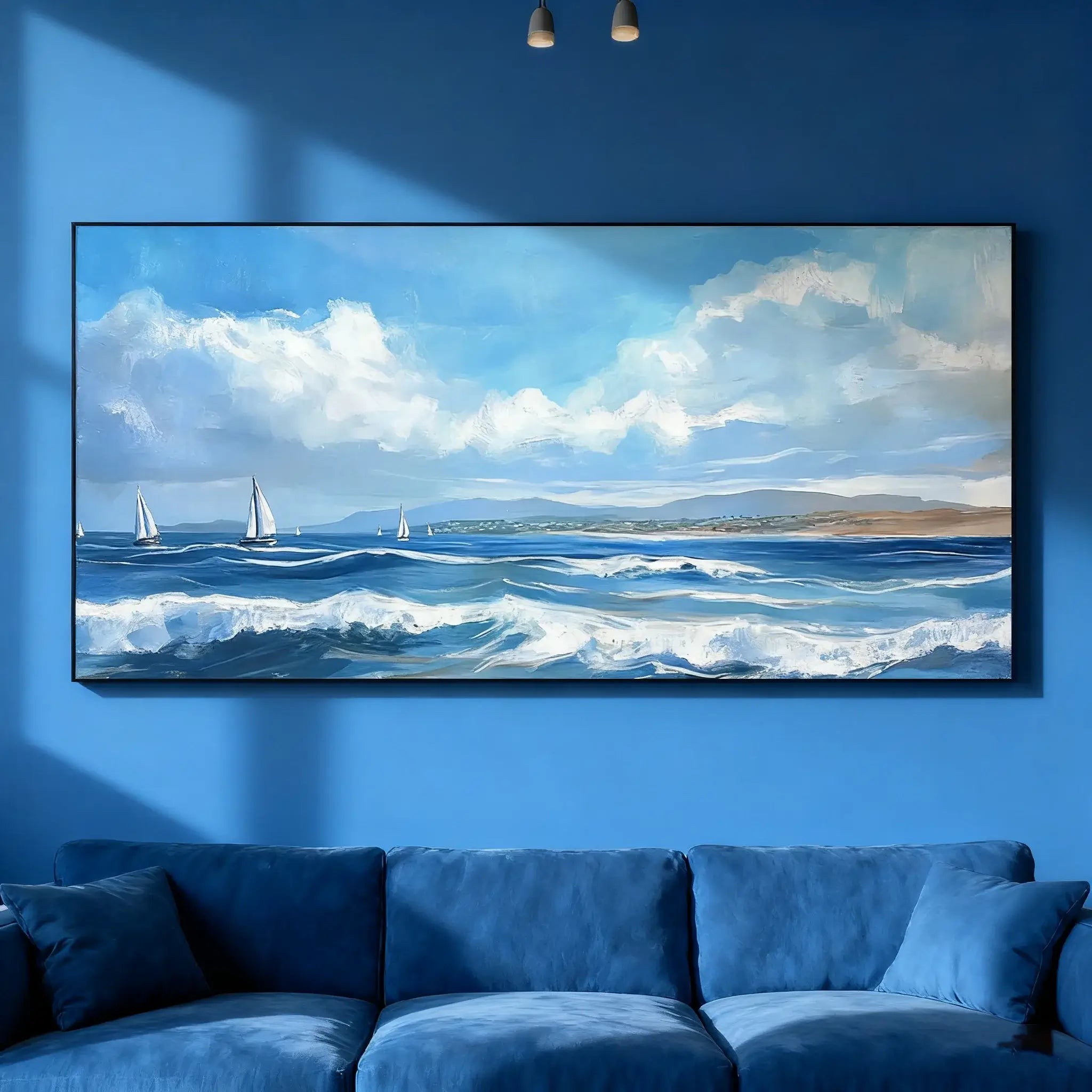 Painting of a seascape with sailboats on a blue wall above a blue sofa.