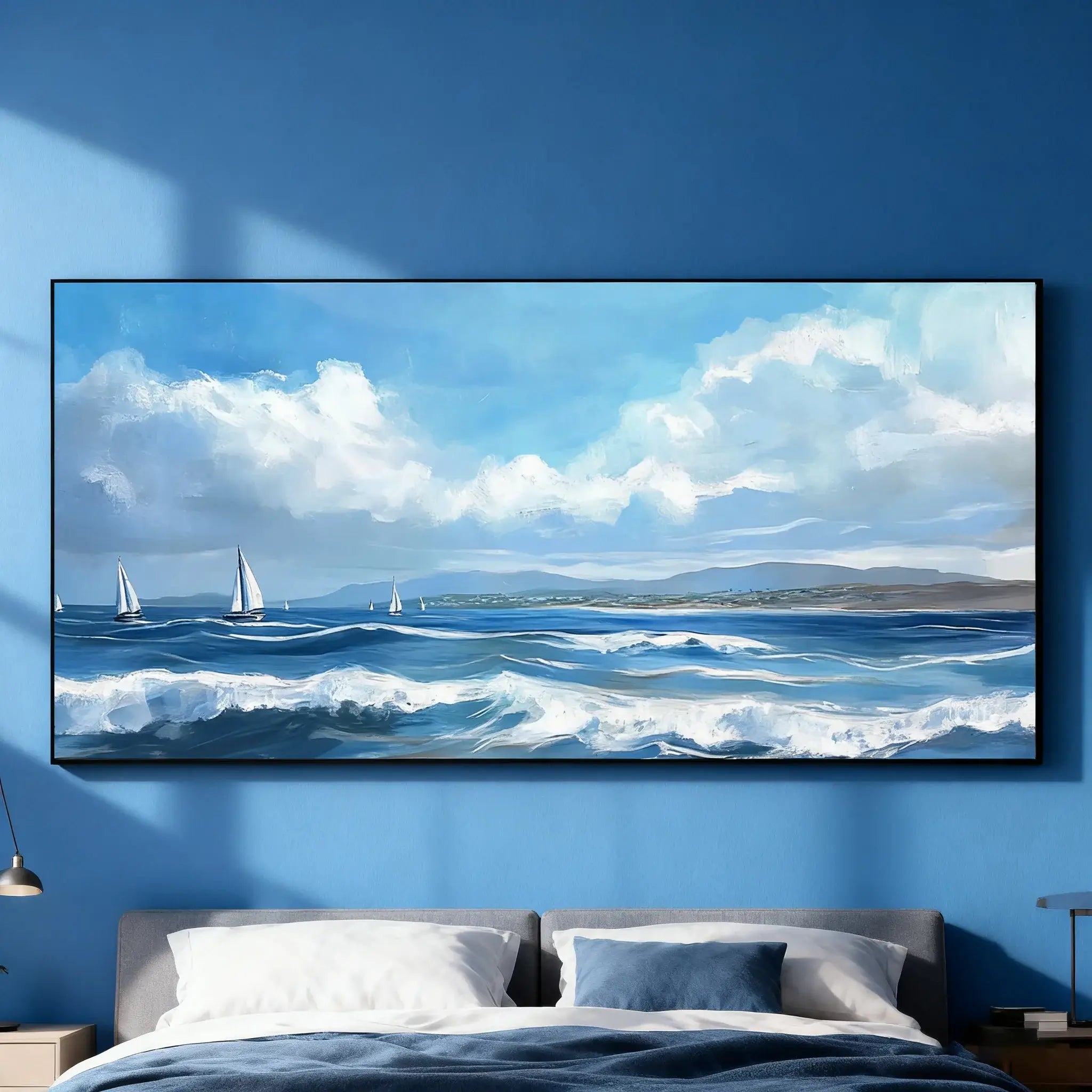 Large seascape painting with sailboats on a blue wall above a bed.