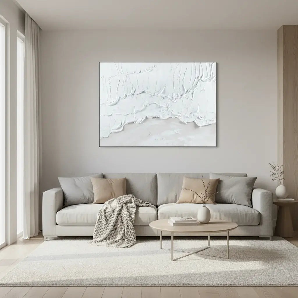 Modern living room with a gray sofa, coffee table, and abstract artwork on the wall.