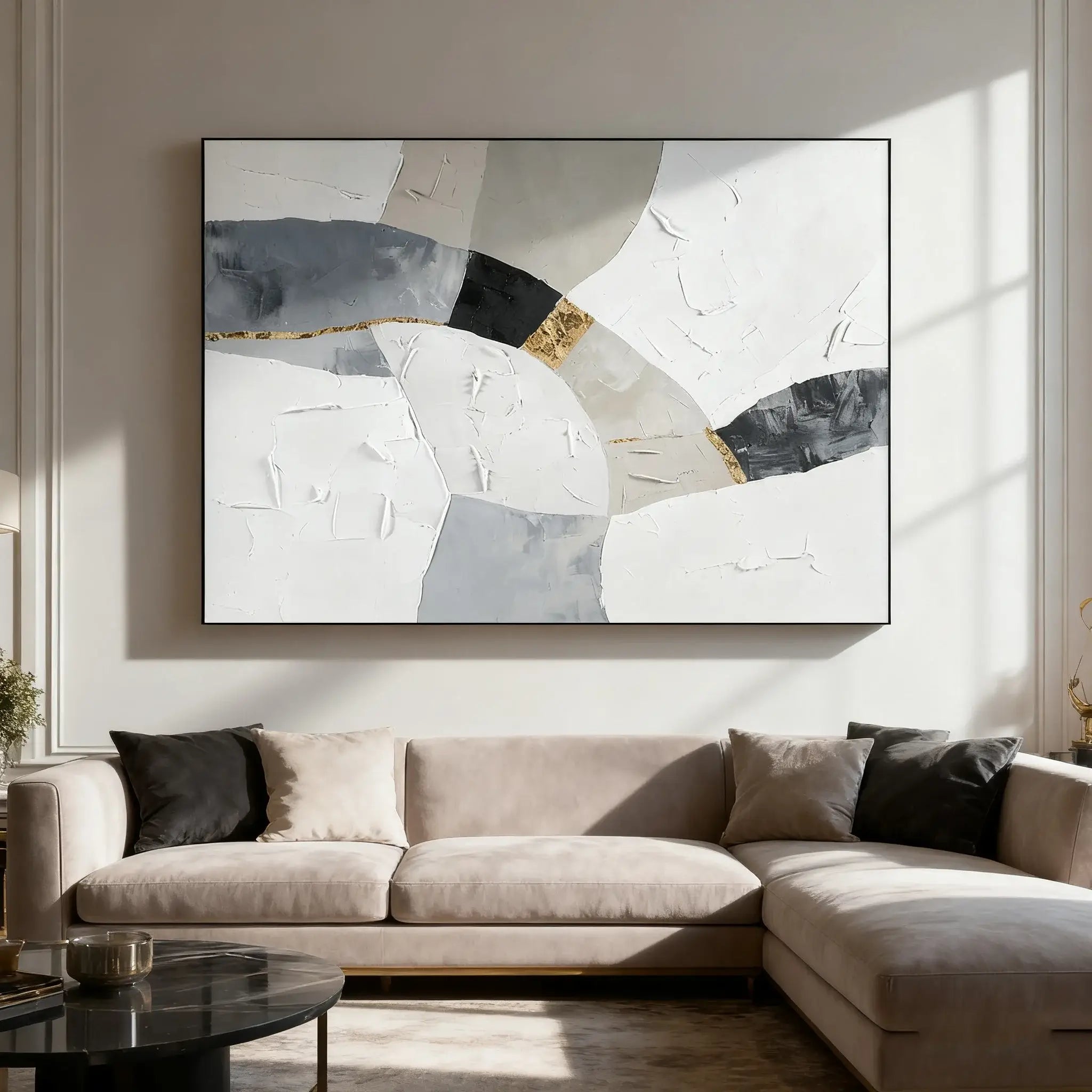 Beige sectional sofa in a living room with abstract art on the wall