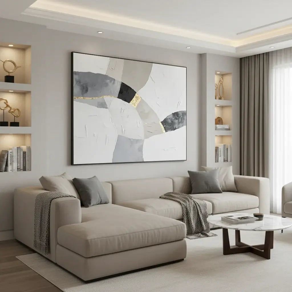 Modern living room with a beige sofa, abstract painting, and decorative shelves.