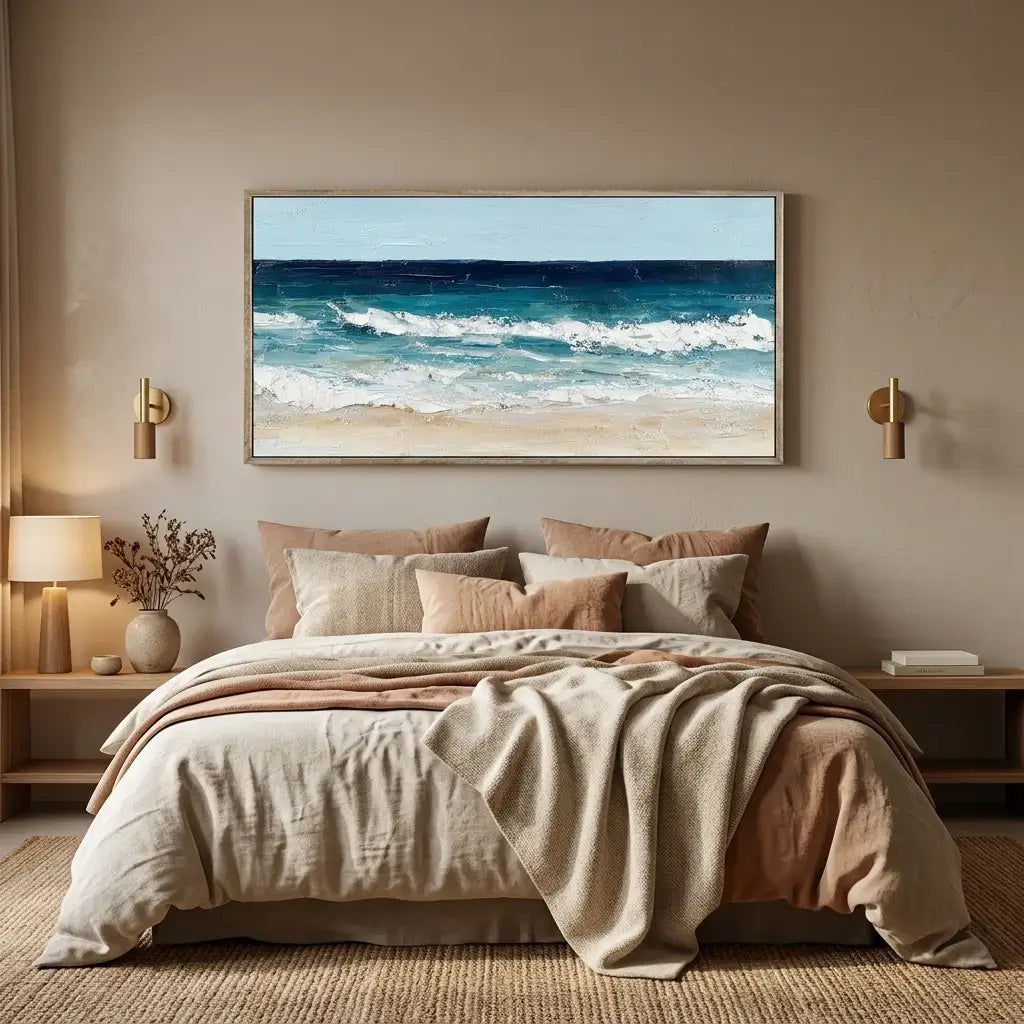 Bedroom with a large framed beach scene on the wall, featuring a bed with beige and brown bedding.