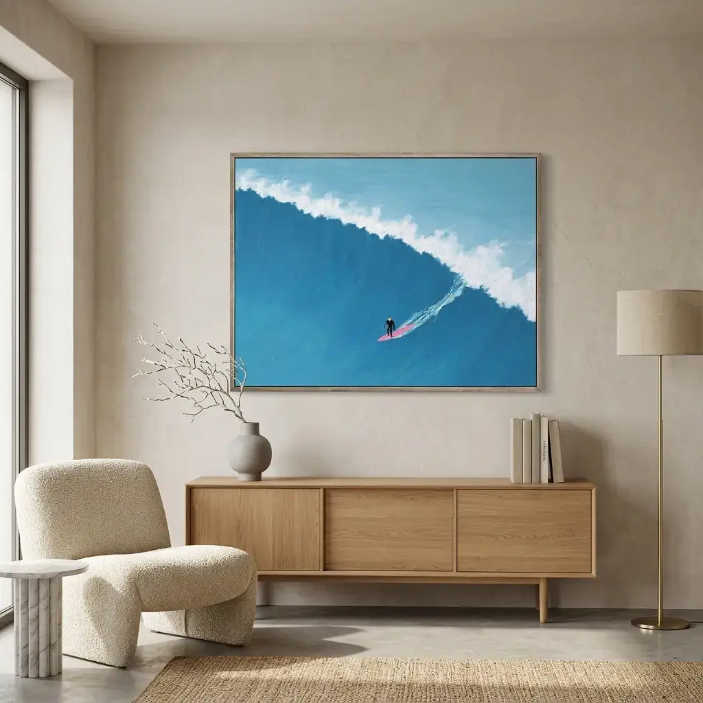 Modern living room with a large framed picture of a surfer on a wave, a wooden sideboard, and a beige armchair.