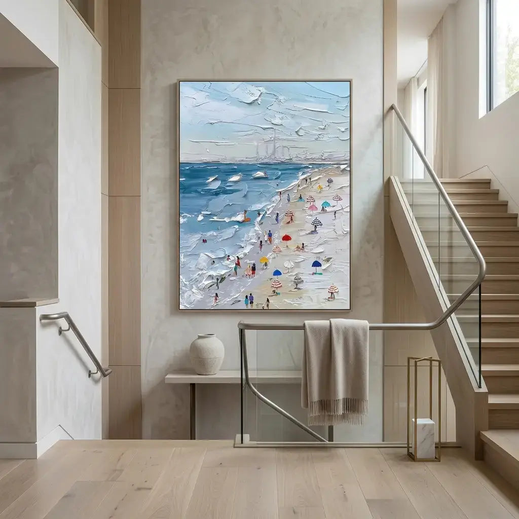 Modern interior with a beach scene painting on the wall above a staircase.