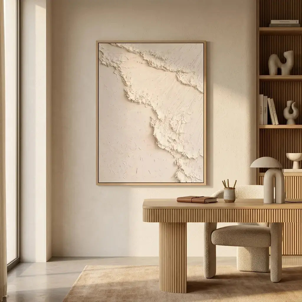 Modern interior with a wooden desk, chair, and framed artwork on a wall.