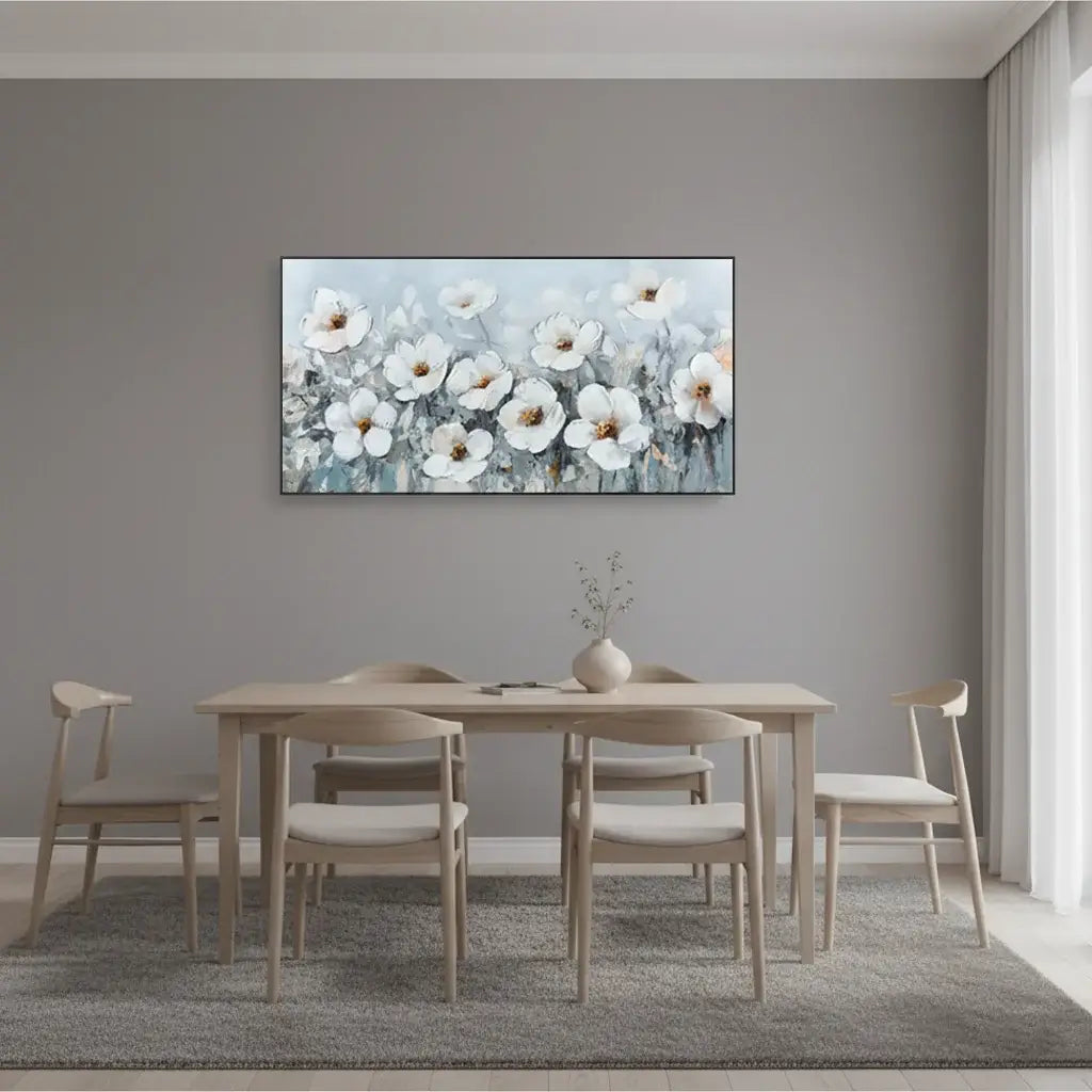 Dining room with a table and chairs, and a floral painting on the wall.