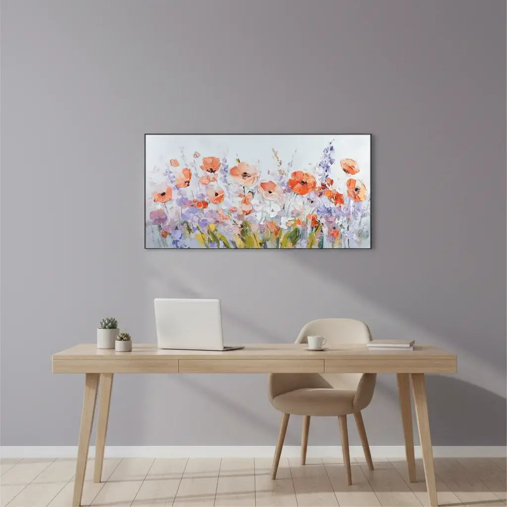 Modern home office with a desk, chair, and floral painting on the wall.