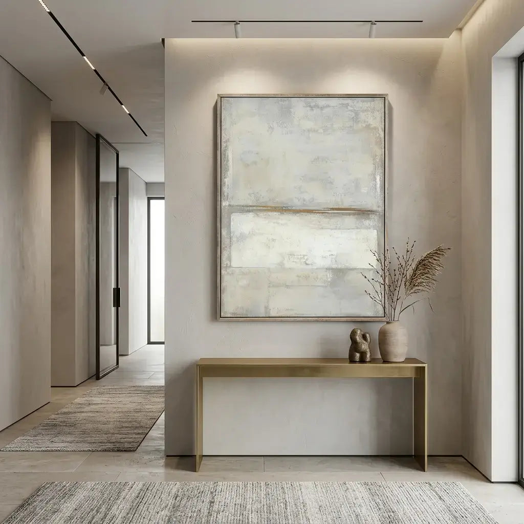 Modern interior hallway with abstract painting and wooden console table.