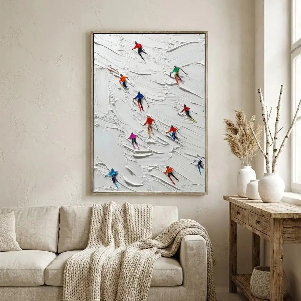 Living room with a framed artwork of skiers on the wall above a beige sofa.
