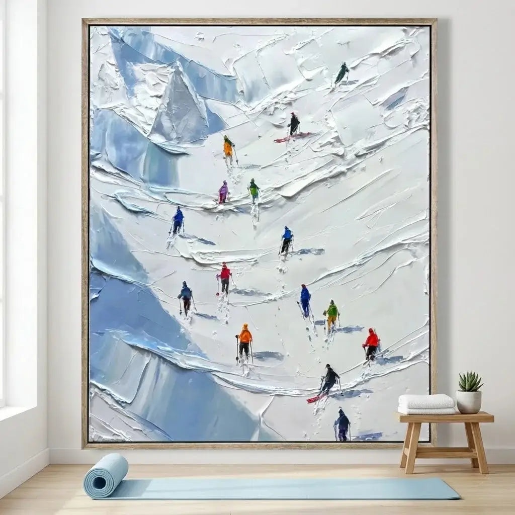 Framed painting of skiers on a snowy mountain in a room with a yoga mat and plant.