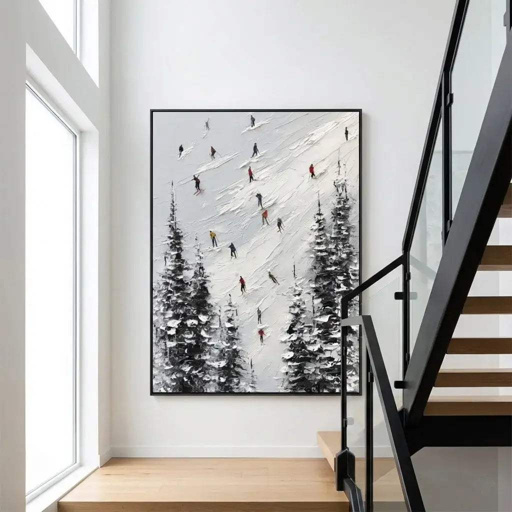 Framed artwork of skiers on a mountain wall above a staircase