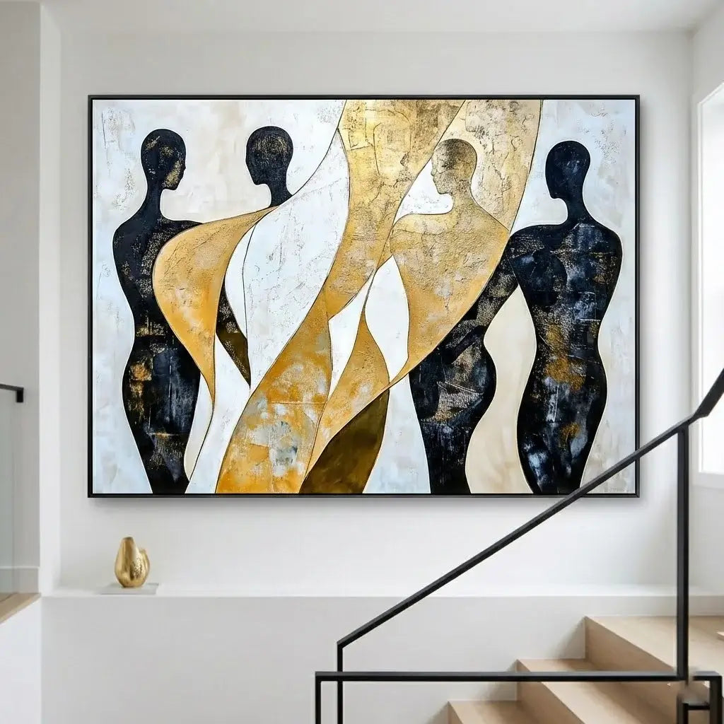Abstract art piece with black, gold, and white figures on a wall above a staircase.