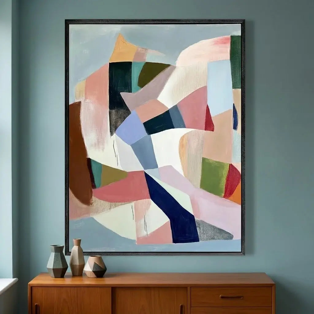 Abstract art piece on a wall above a wooden cabinet with decorative vases.