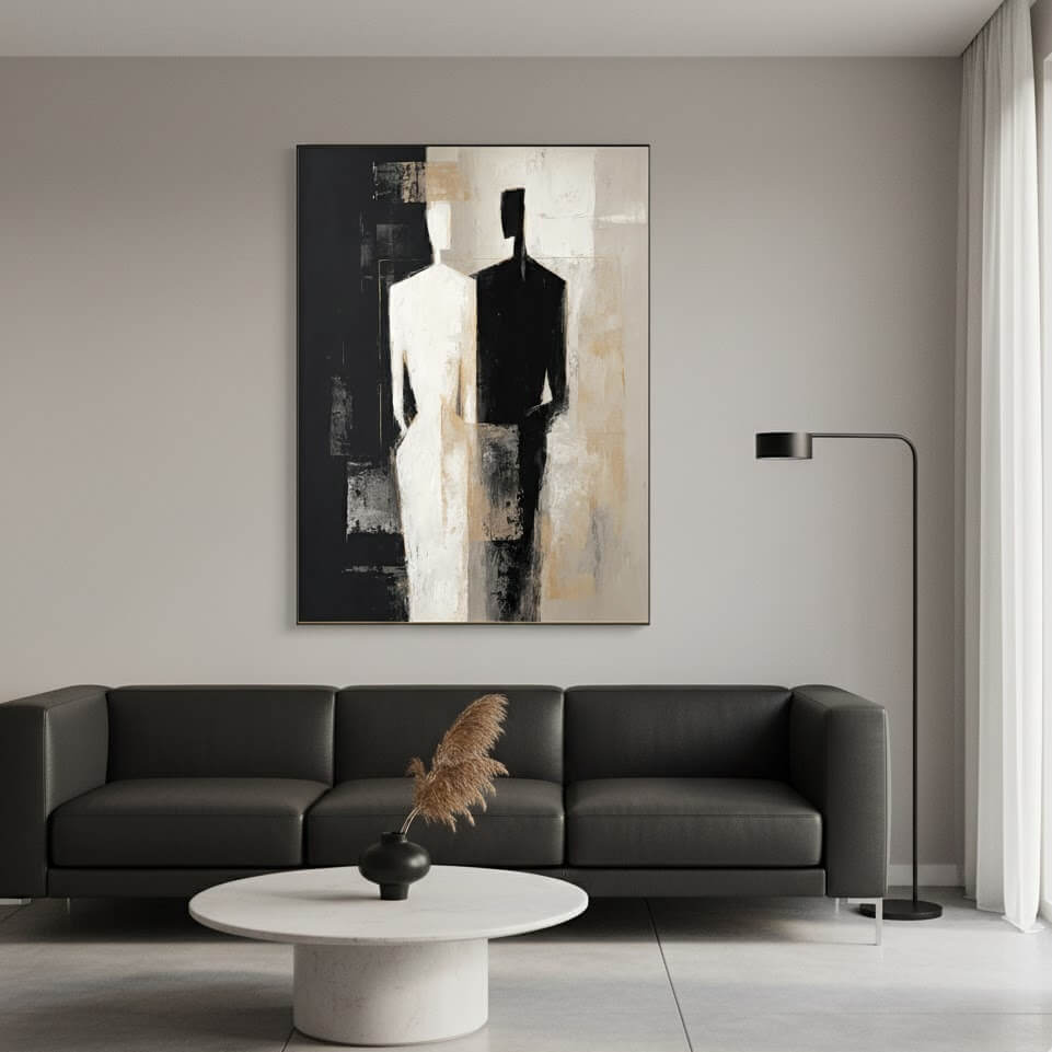 Modern living room with a black sofa, white coffee table, and abstract art on the wall.