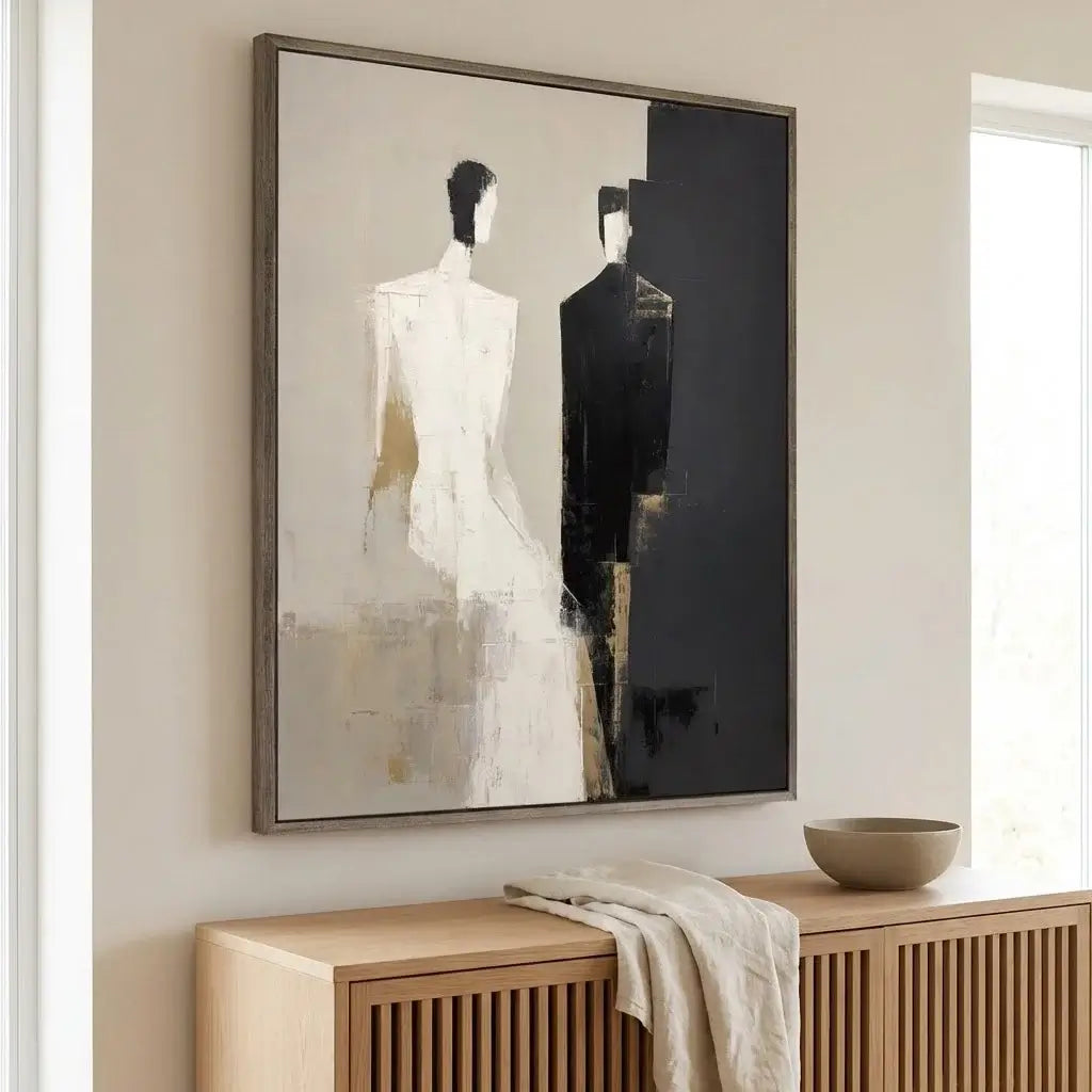 Abstract art piece on a wall above a wooden console table.