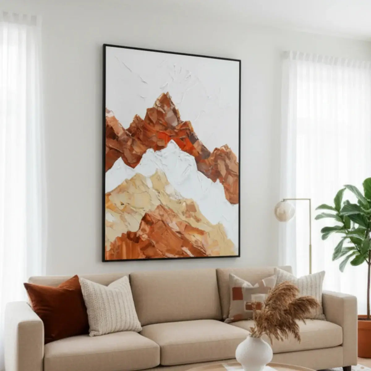 Living room with a beige sofa, decorative pillows, and a large abstract mountain painting on the wall.