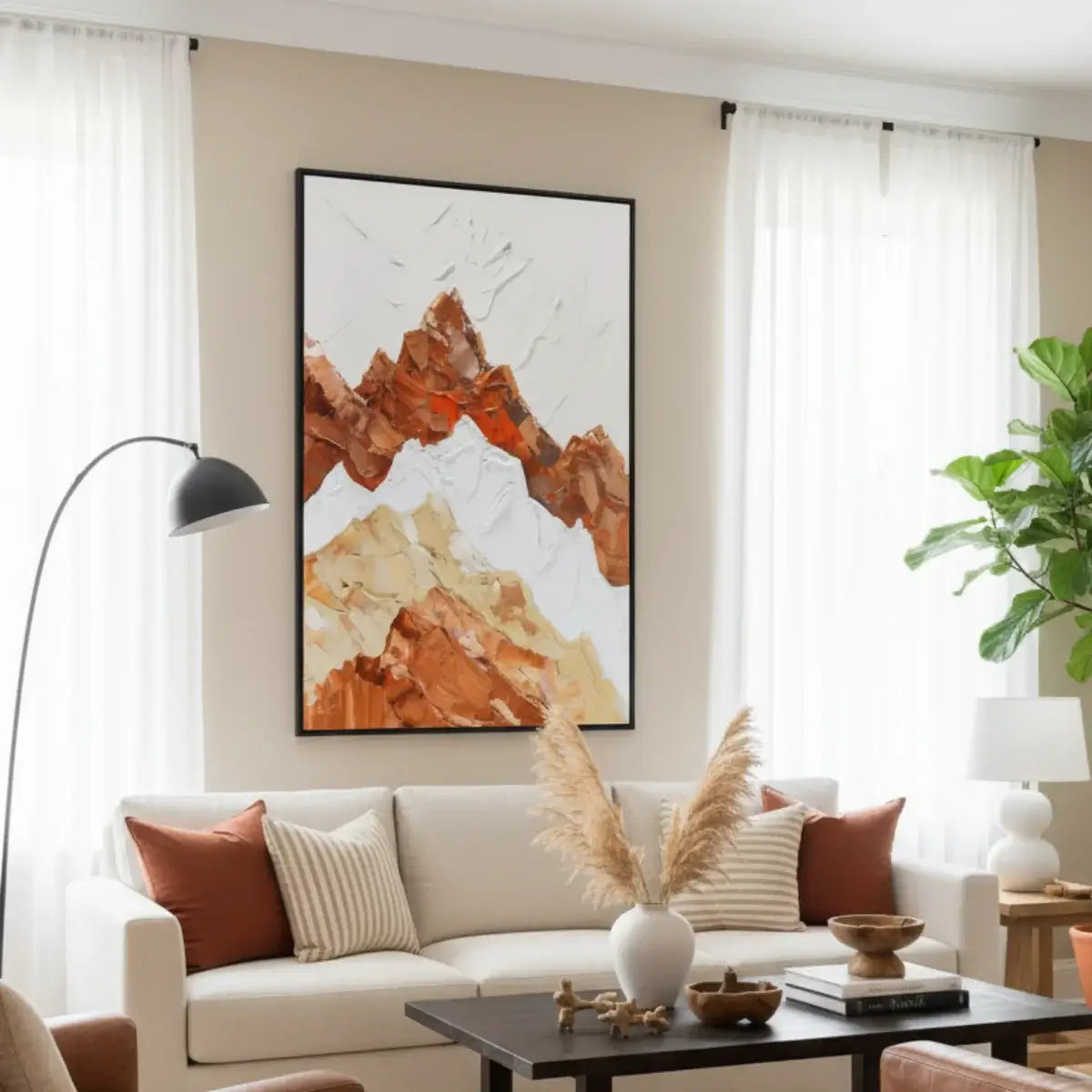 Living room with a beige sofa, abstract mountain painting, and decorative elements.