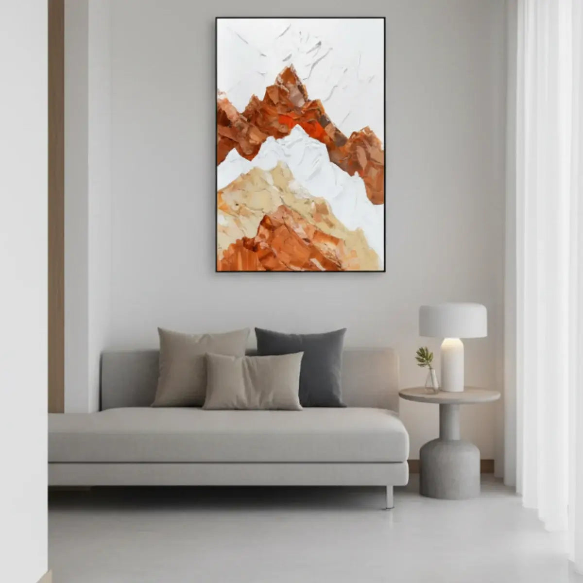 Abstract art piece on a wall above a sofa in a living room.