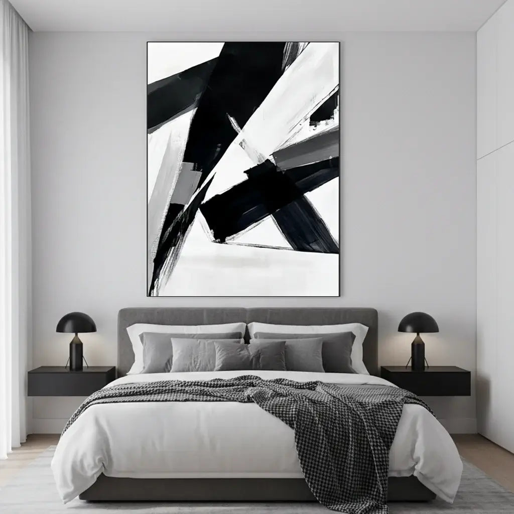 Modern bedroom with abstract black and white artwork on the wall