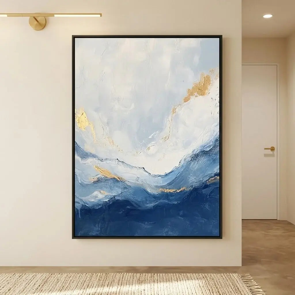 Abstract painting with blue and gold tones above a bed in a bedroom setting.