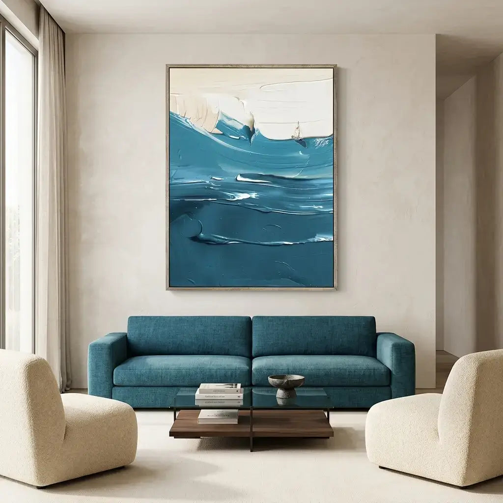 Modern living room with a blue sofa, abstract art, and neutral decor.