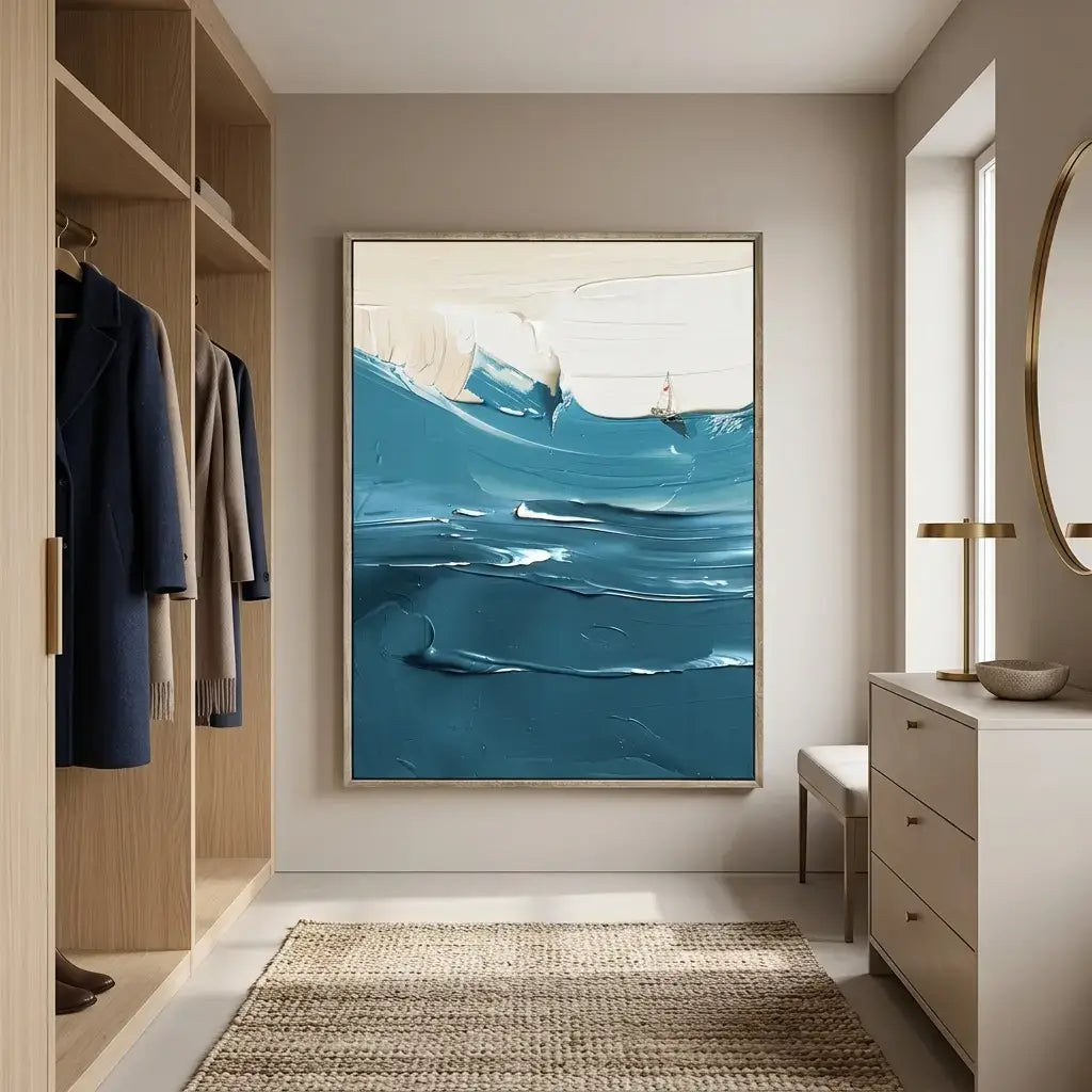 Modern interior with a large abstract painting of blue waves, wooden shelves with coats, and a dresser.
