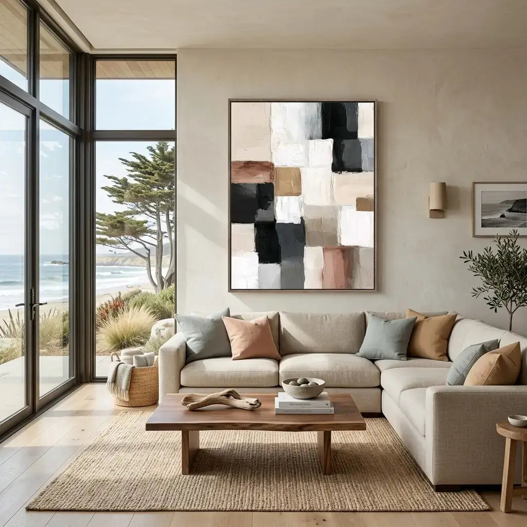 Modern living room with a sectional sofa, abstract painting, and ocean view.
