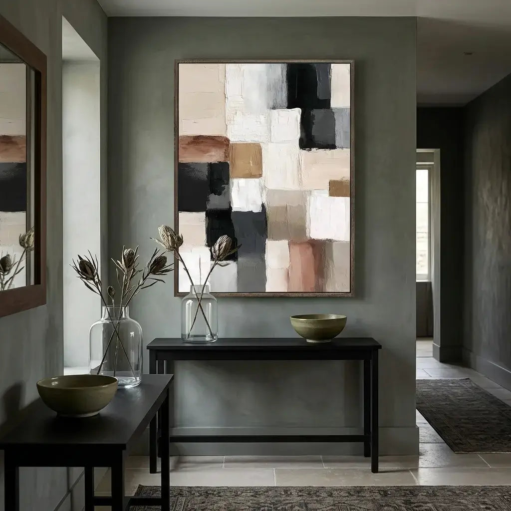 Modern interior with abstract wall art, dark wood console table, and decorative bowls.