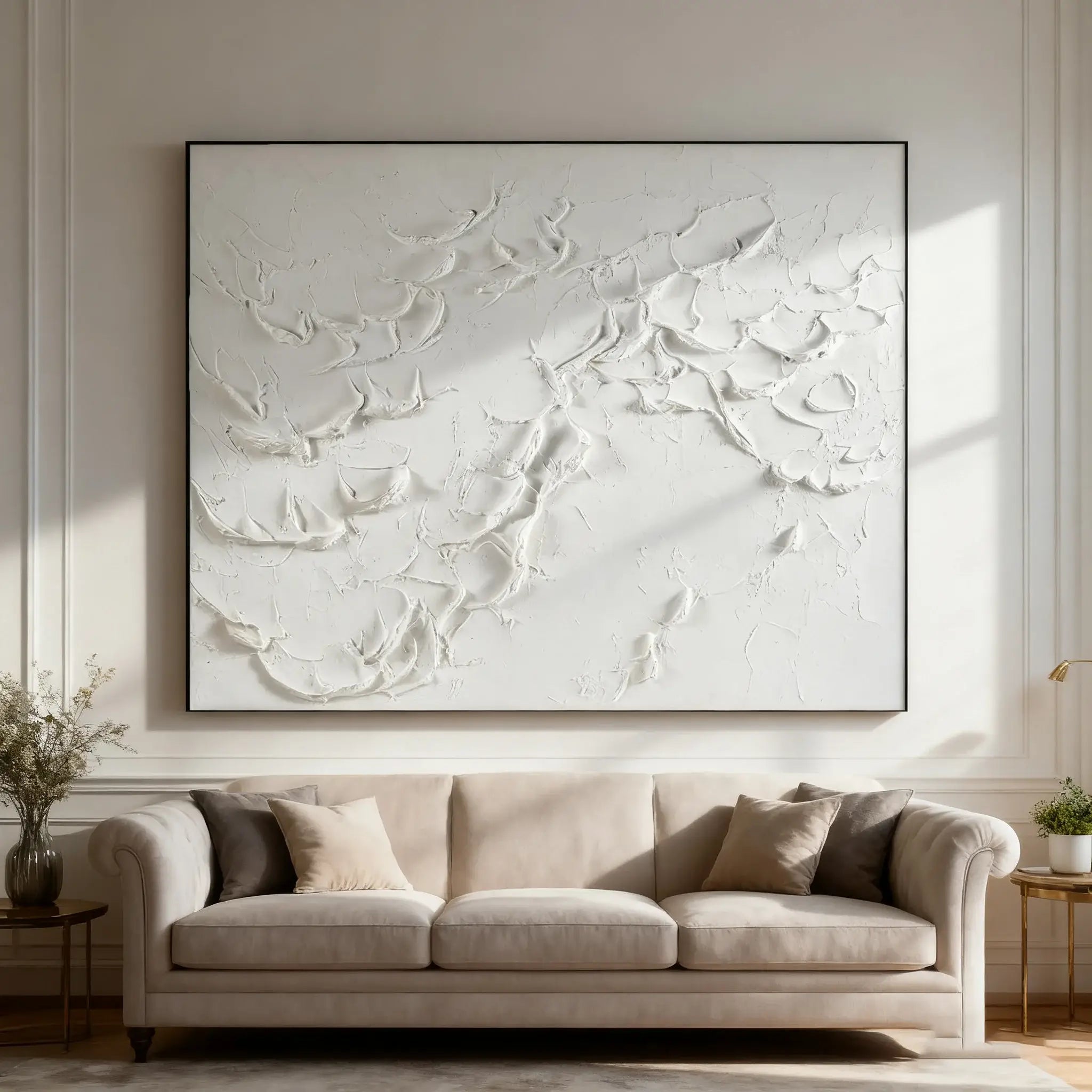 Abstract wall art above a beige sofa in a living room setting