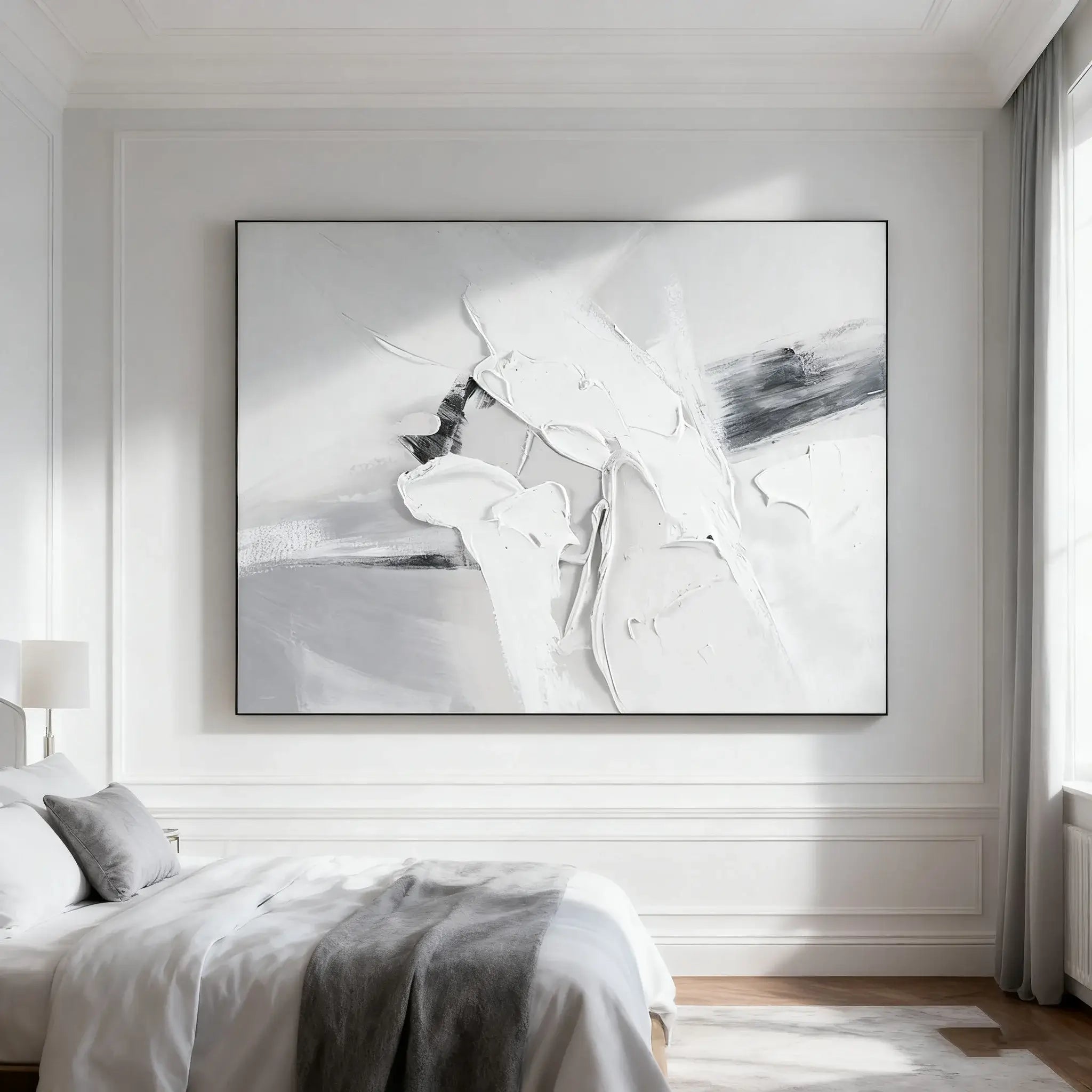 Abstract black and white painting on a wall in a bedroom