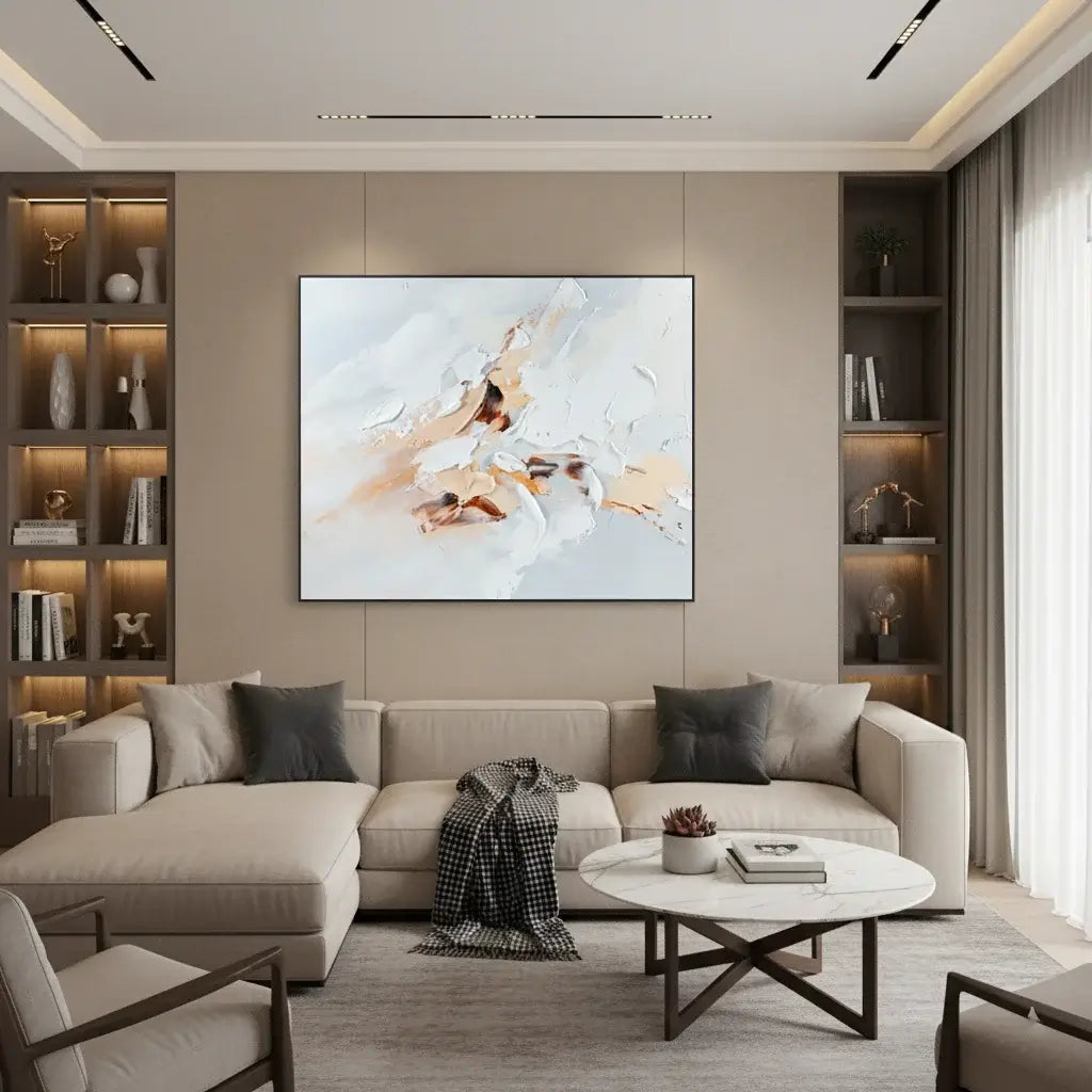 Modern living room with a beige sofa, abstract painting, and bookshelves.