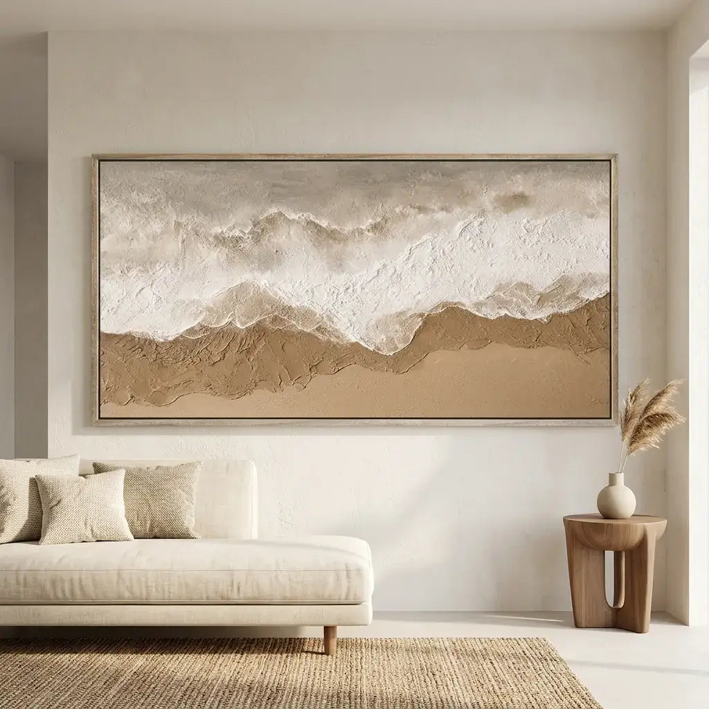 Beige abstract mountain painting on a wall above a beige sofa in a living room.