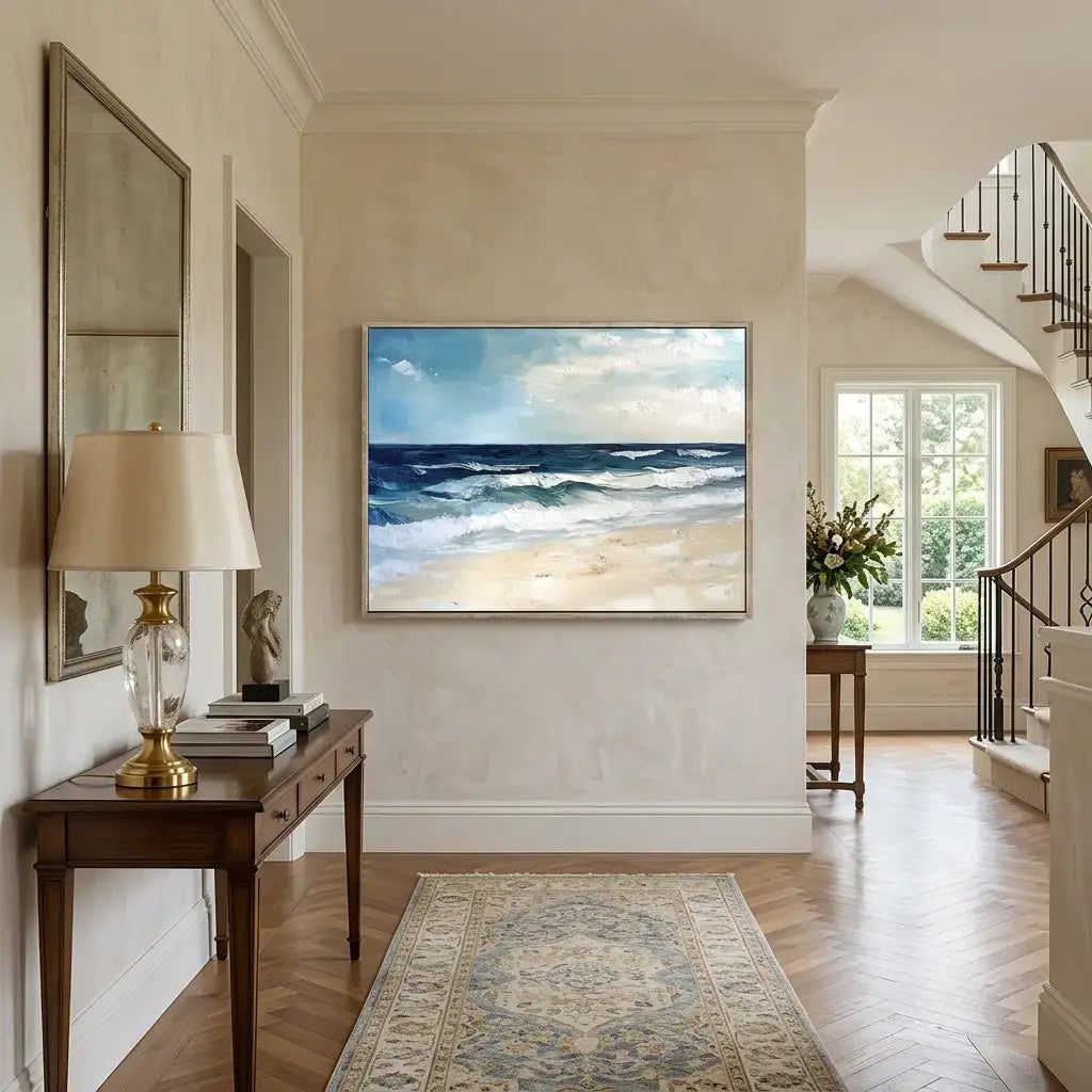 Living room with a large ocean painting on the wall, wooden side table, and lamp.
