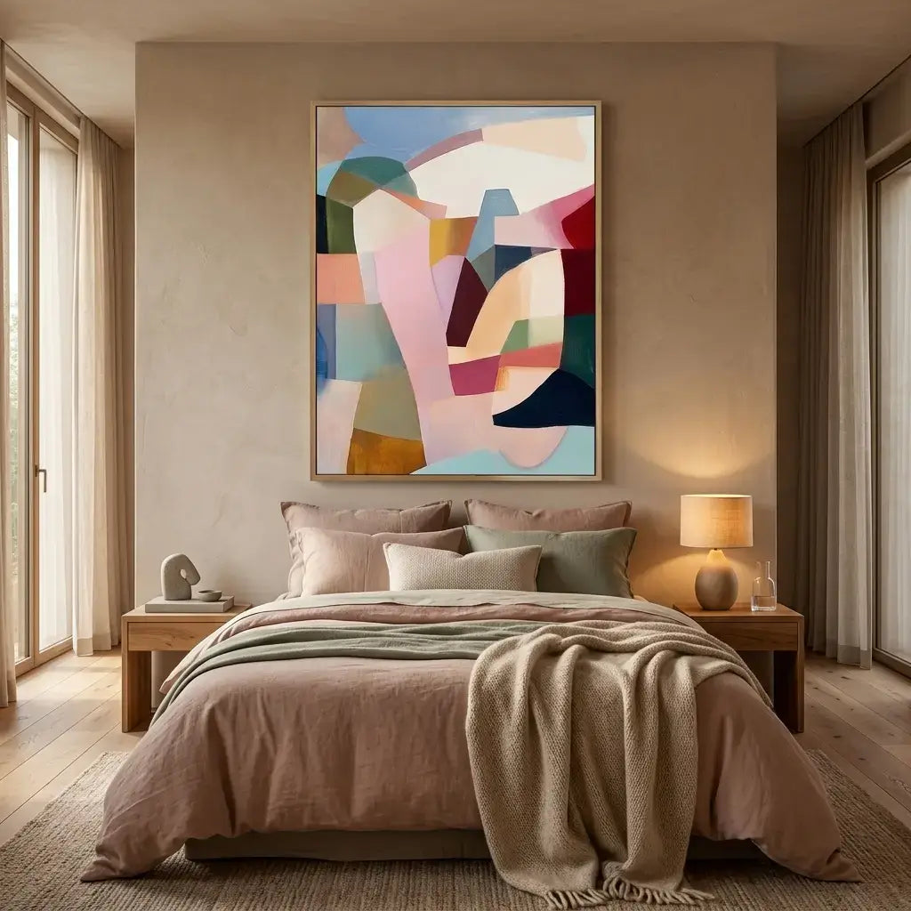 Modern bedroom with a bed, abstract art, and side tables.