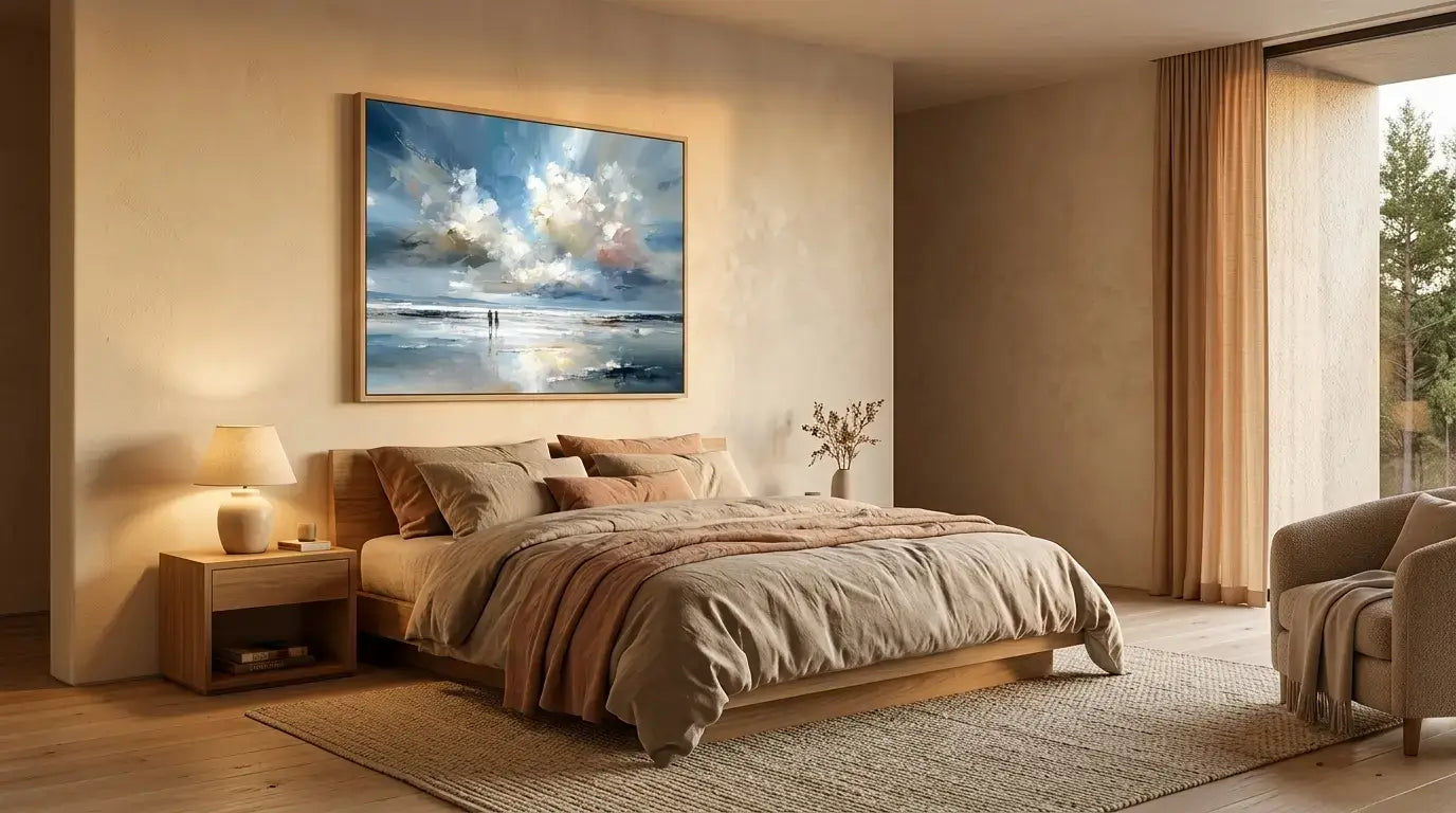 Modern bedroom with a large bed, side tables, and a painting of a beach scene on the wall.