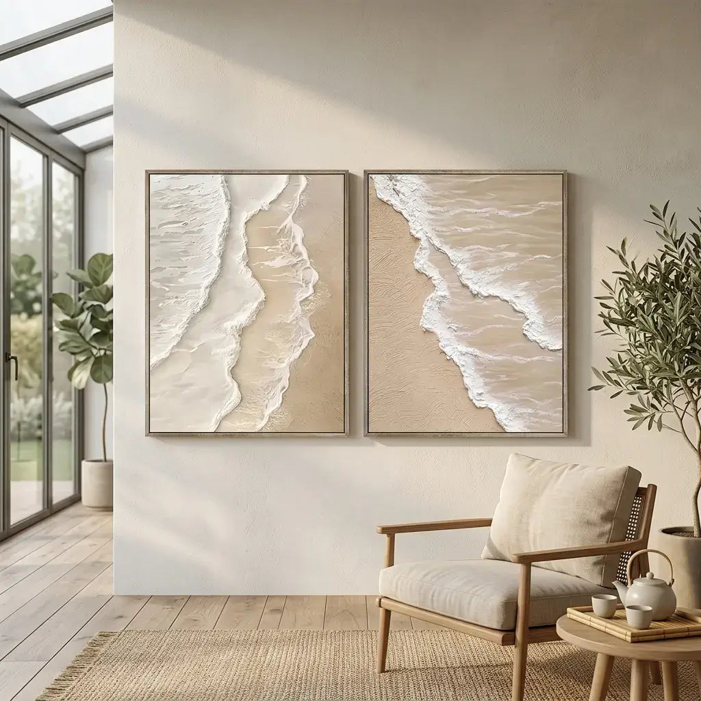 Two beach-themed wall art pieces above a wooden armchair in a modern living room.