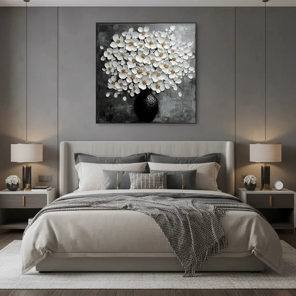 Modern bedroom with a bed, nightstands, and wall art featuring white flowers.
