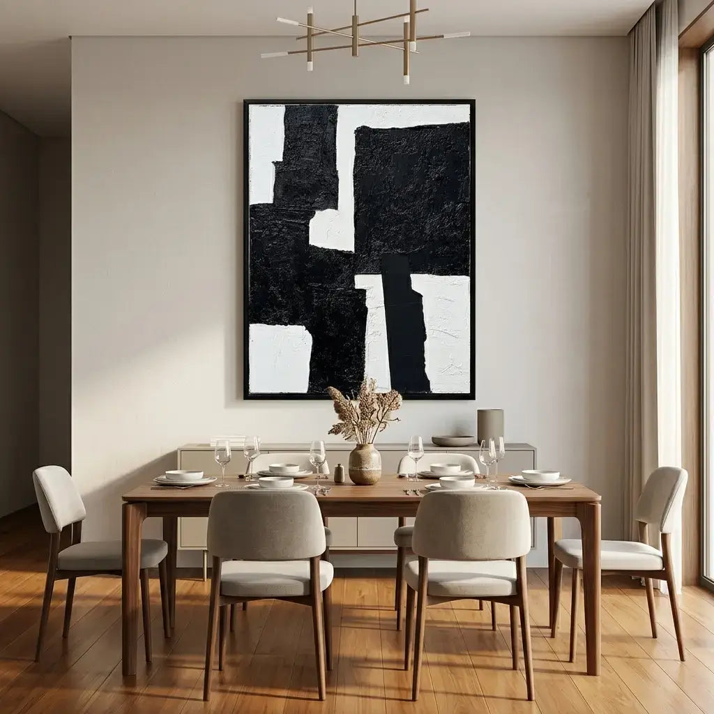 Dining room with wooden table and chairs, abstract art on the wall, and a vase with flowers.
