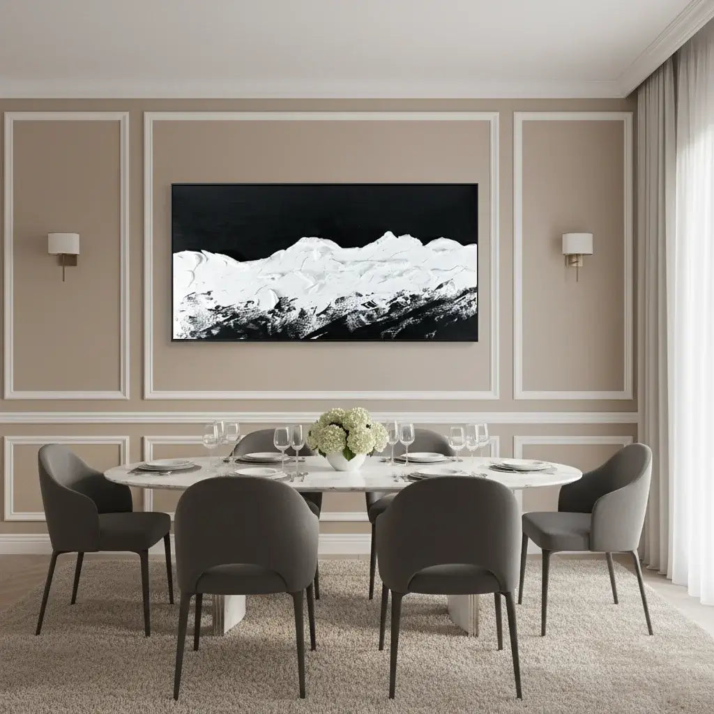 Modern dining room with a round table and gray chairs, featuring a large black and white abstract painting on the wall.