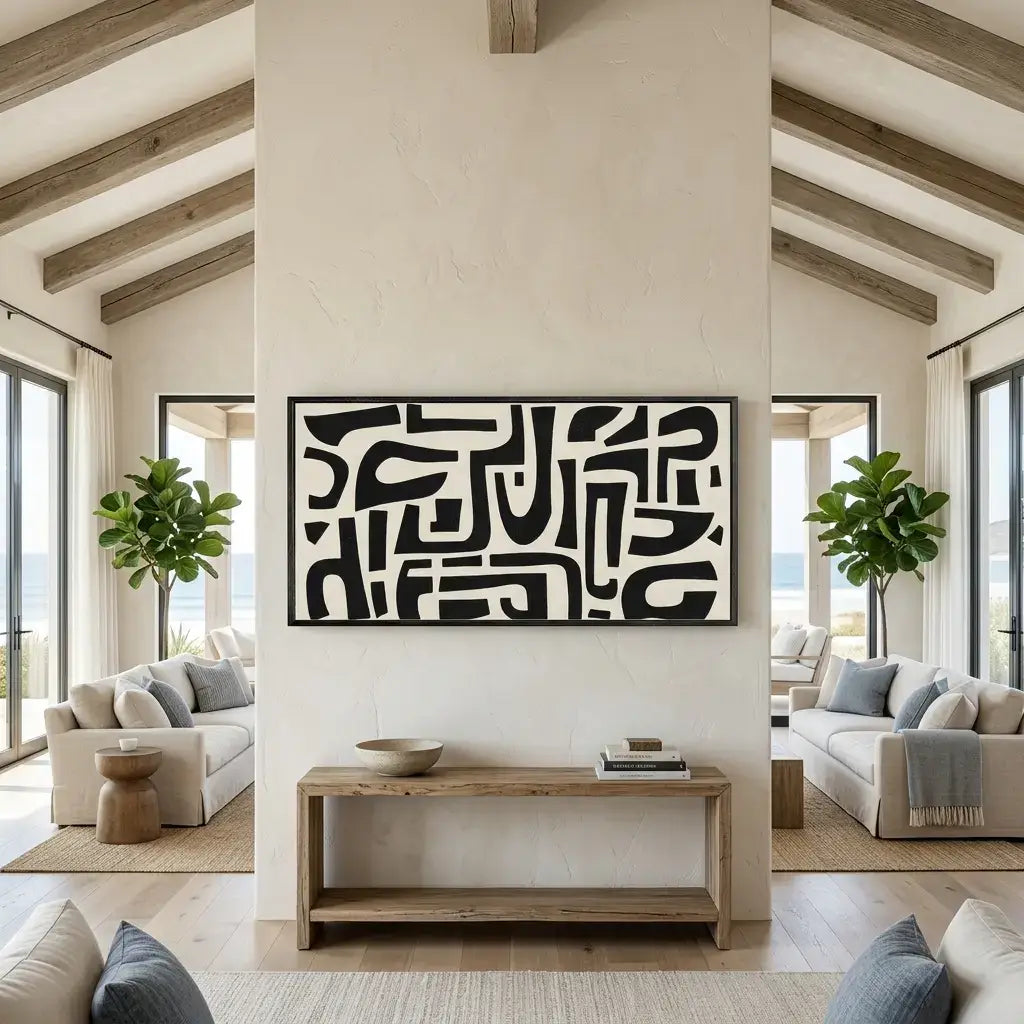 Modern living room with abstract black and white artwork on a neutral wall.