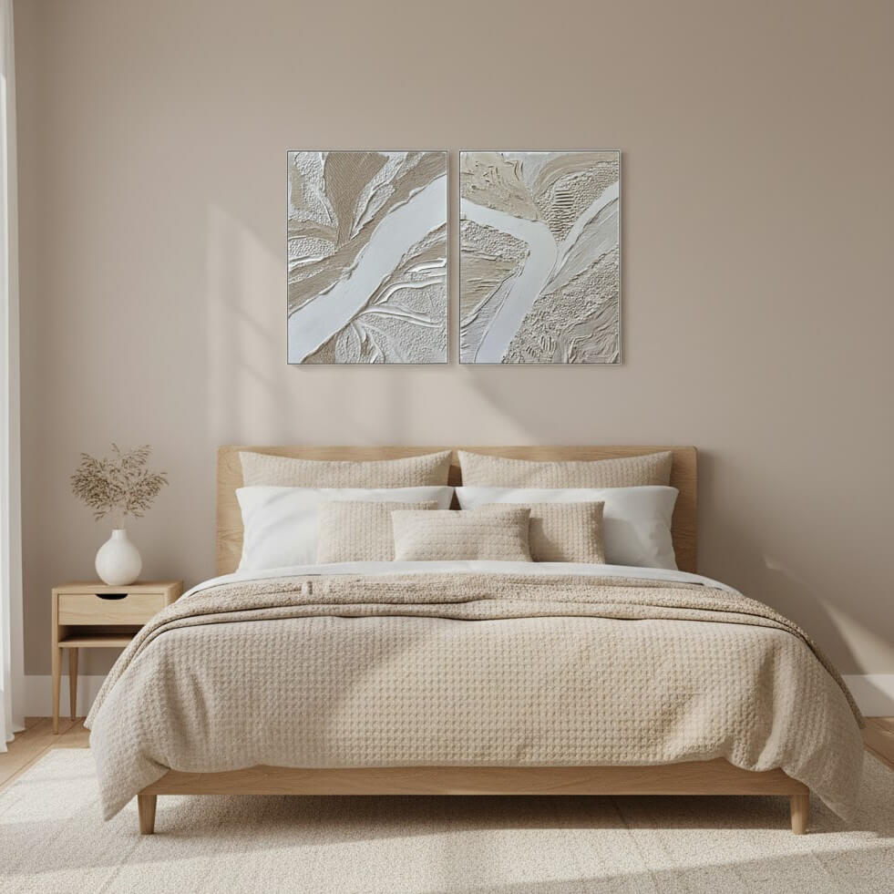 Beige bedroom with a bed, nightstand, and abstract wall art.