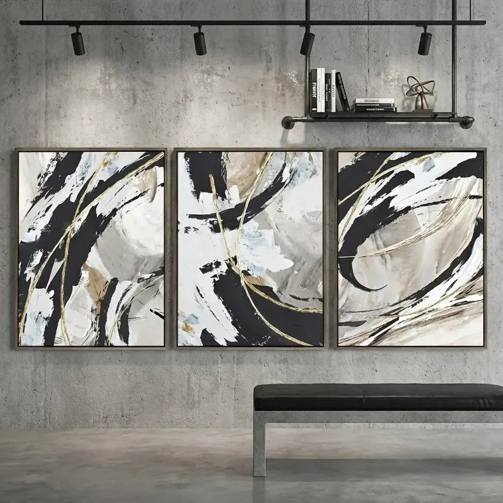 Three abstract art pieces on a wall with a bench below.