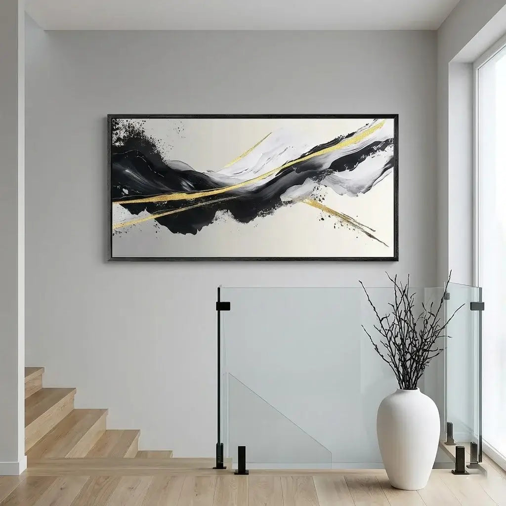 Abstract art piece on a wall in a modern interior setting with stairs and decor.