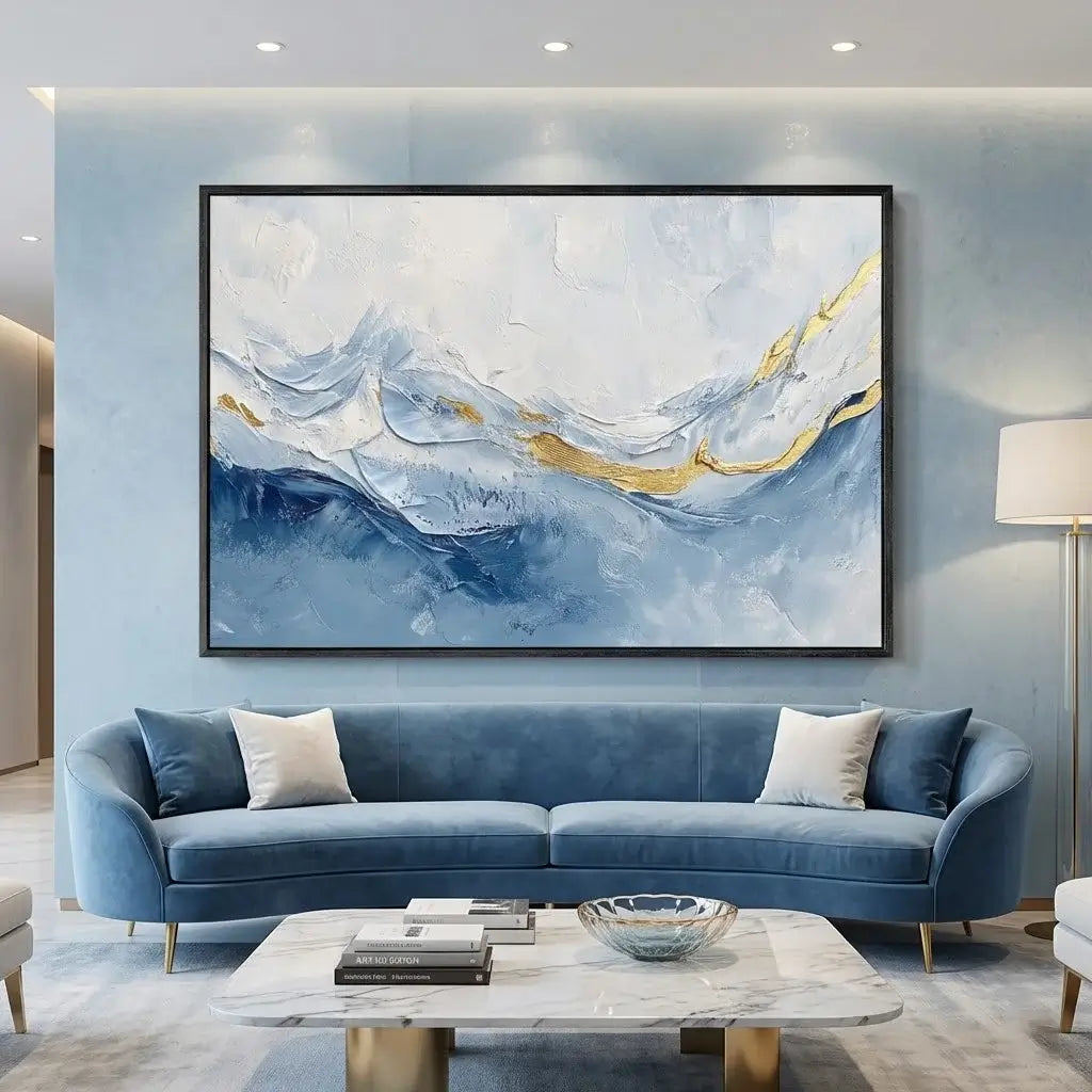 Modern living room with a blue sofa, abstract painting, and marble coffee table.