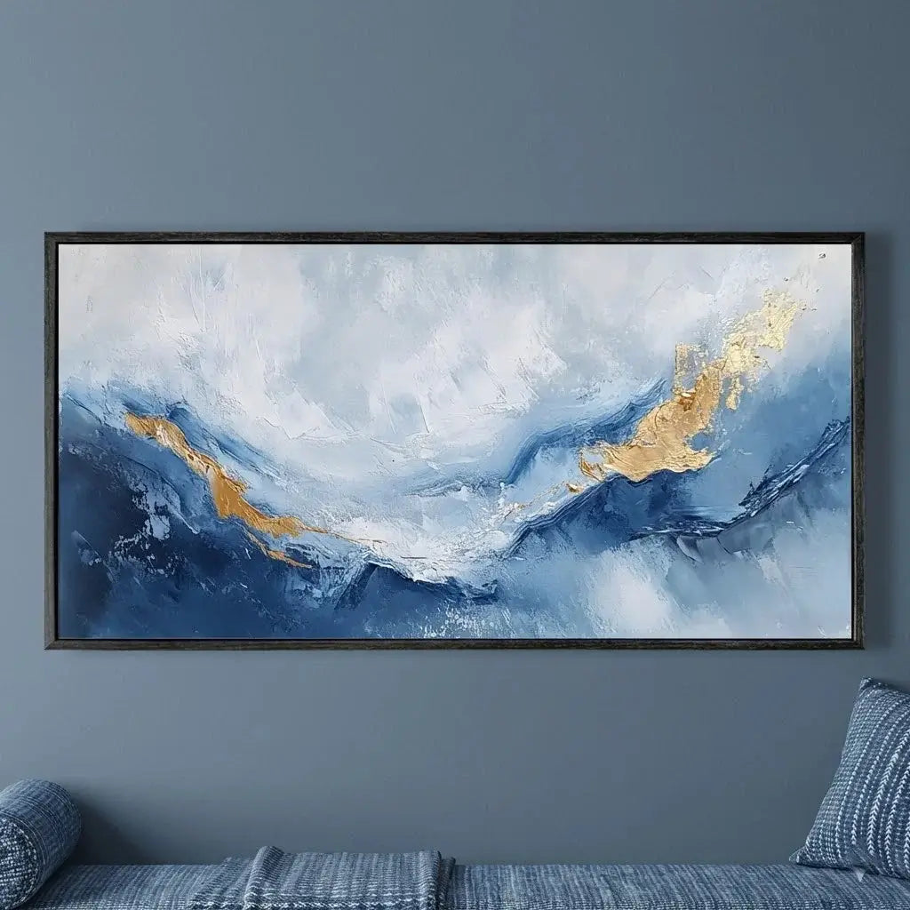 Abstract painting with blue and gold tones on a gray wall above a sofa.