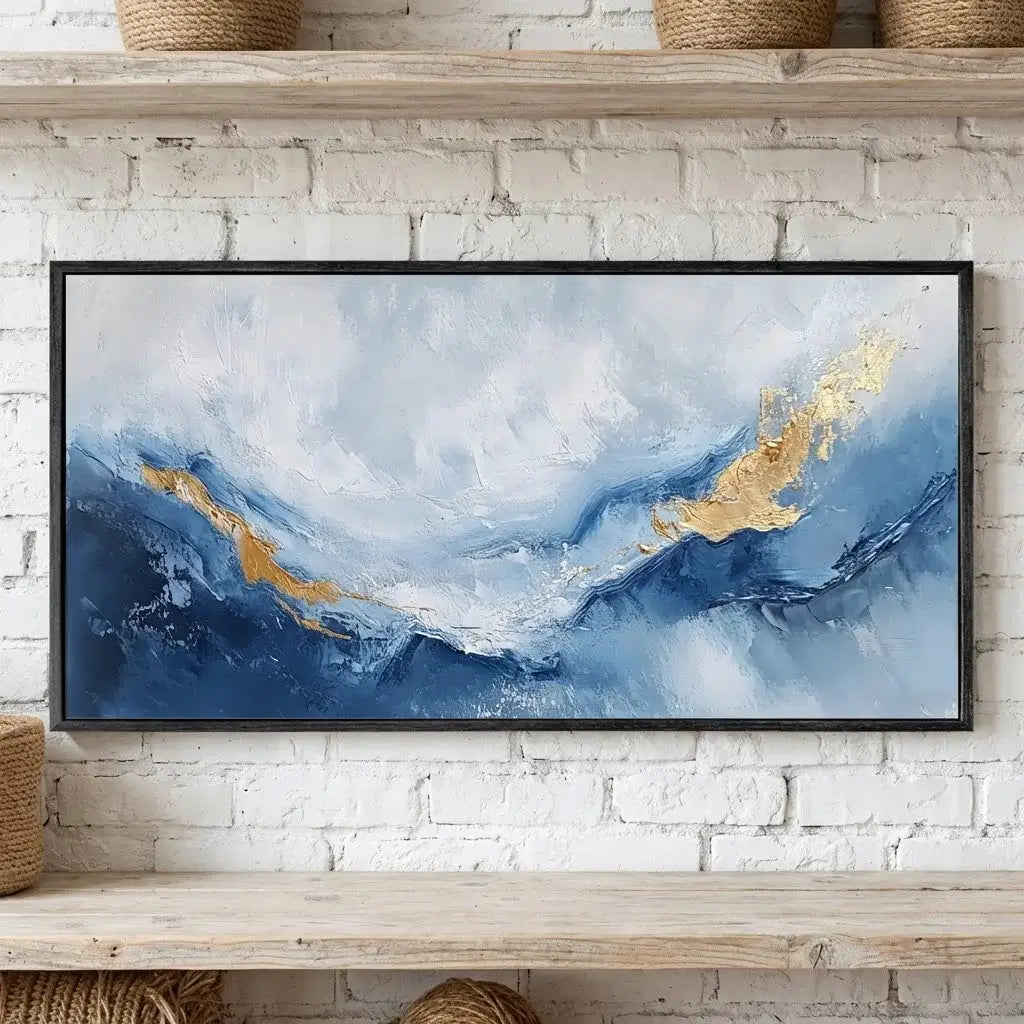 Abstract painting with blue and gold tones on a white brick wall
