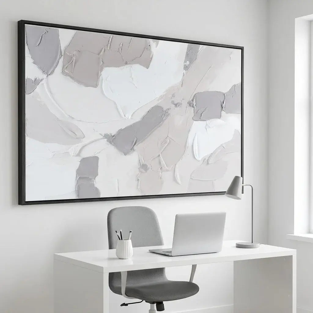 Modern office setup with a desk, chair, laptop, and abstract art on the wall.
