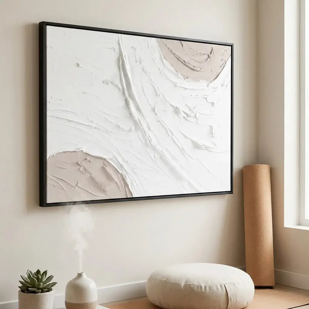 Abstract art piece in a black frame on a wall with minimal decor.