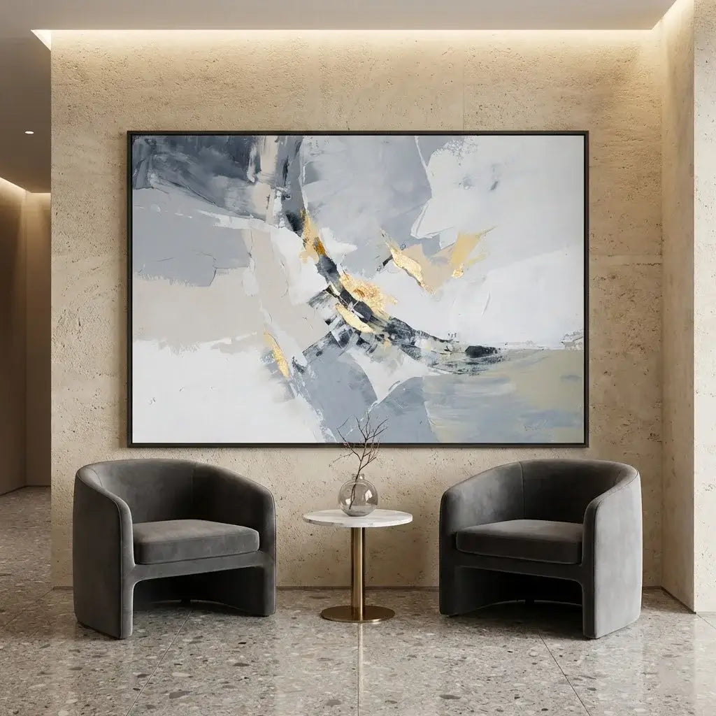 Modern interior with abstract art on the wall, two gray chairs, and a small round table.
