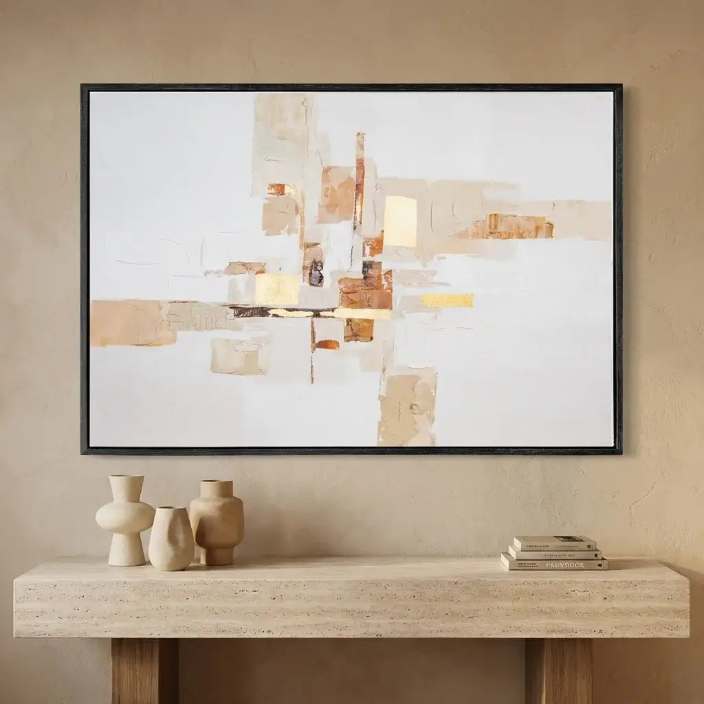 Abstract art piece on a wall above a wooden console table with decorative items.